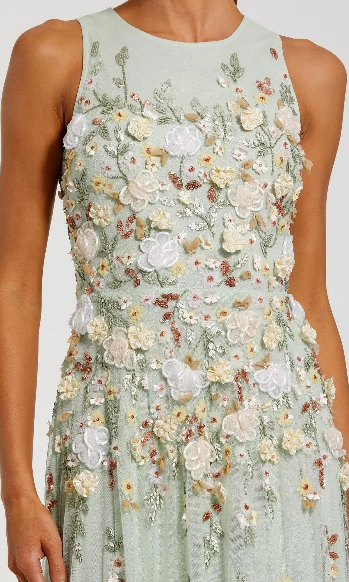 The Long Formal Dress: Mac Duggal 9334 is a sleeveless, pale green gown adorned with intricate floral embroidery and appliqué in white, cream, yellow, and pink.